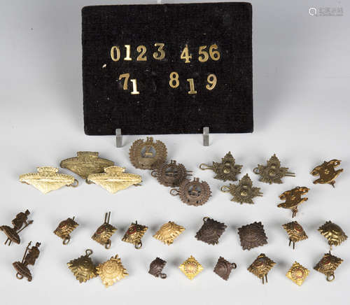 A large collection of early 20th century military cap badges...