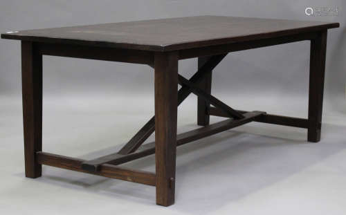 A modern hardwood rectangular dining table, raised on block ...