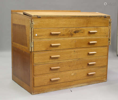 A mid-20th century oak two-section planner's chest, the slop...