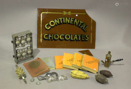 A group of chocolate making items, including moulds, presses...