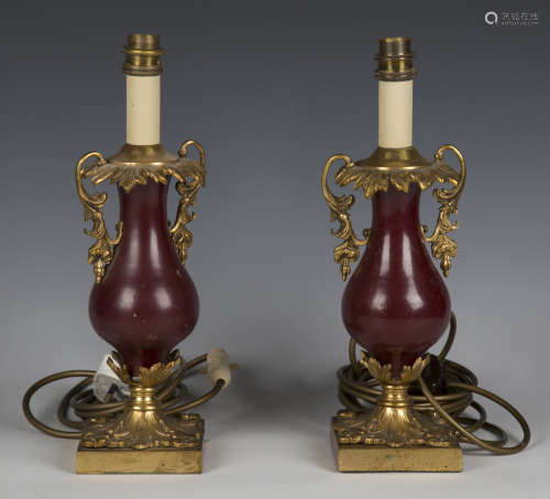 A pair of early 20th century gilt metal and claret lacquered...