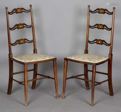 A pair of Edwardian Arts and Crafts beech and mahogany pierc...