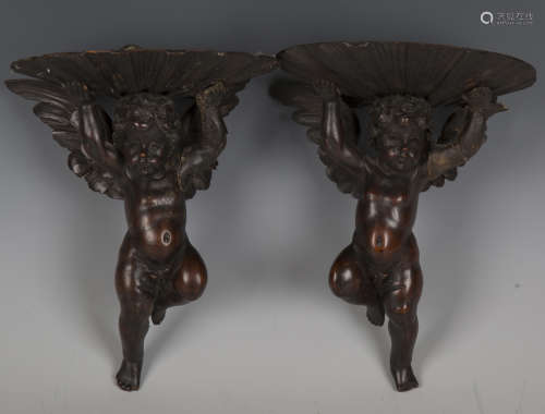 A pair of early 20th century carved wood cherub wall bracket...