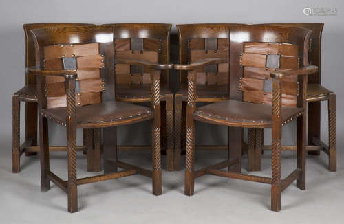 A set of six Arts and Crafts oak framed dining chairs, the d...
