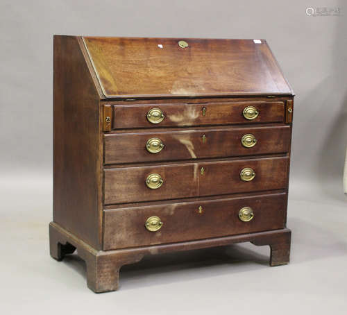 A George III mahogany bureau, the fall flap above four gradu...