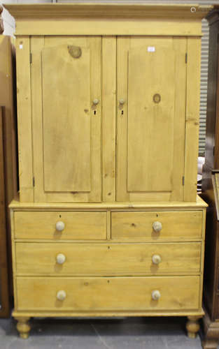 A late Victorian pine linen press, fitted with a pair of pan...