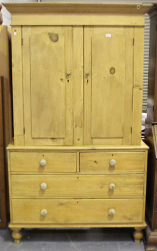 A late Victorian pine linen press, fitted with a pair of pan...