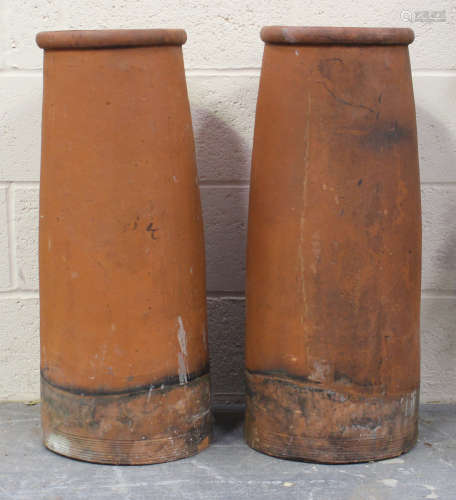 A pair of terracotta chimneys, height 77cm, diameter 30cm.Bu...