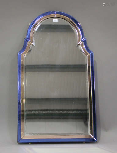 An Art Deco arched wall mirror with a sectional blue and pea...