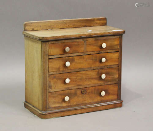 A Victorian mahogany table-top chest of drawers with turned ...