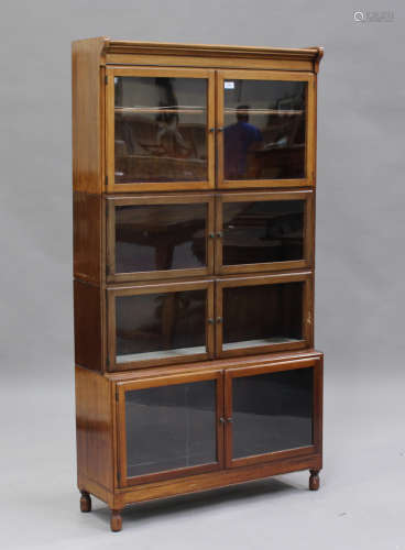 An early 20th century walnut glazed sectional bookcase by Mi...