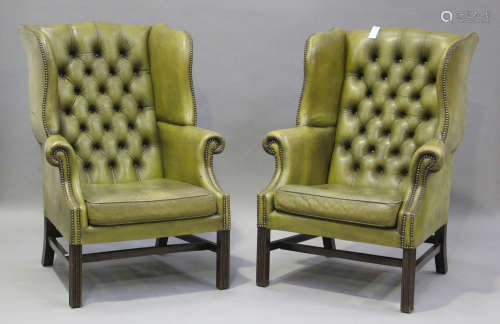 A pair of 20th century George III style wing back armchairs,...