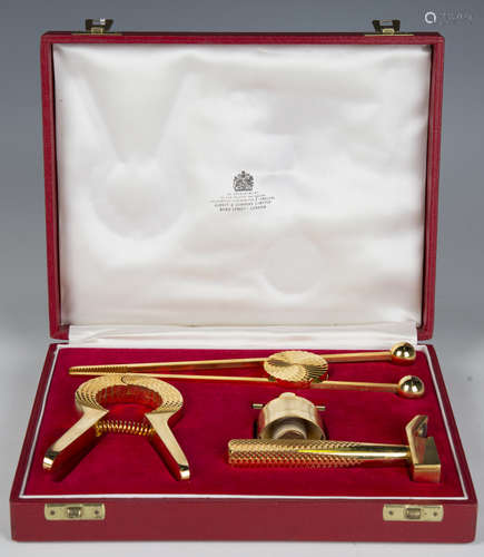 An Asprey gilt metal bar tool set, boxed, width 23cm.Buyer’s...