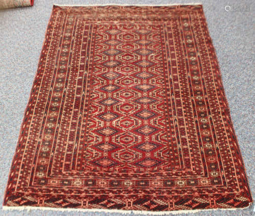 A Turkoman style rug, 20th century, the claret field with tw...