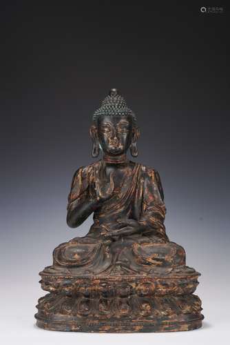 A PARCIL GILT BRONZE FIGURE OF SHAKYAMUNI