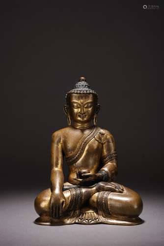 A PARCEL GILT COPPER FIGURE OF SEATED SHAKYAMUNI