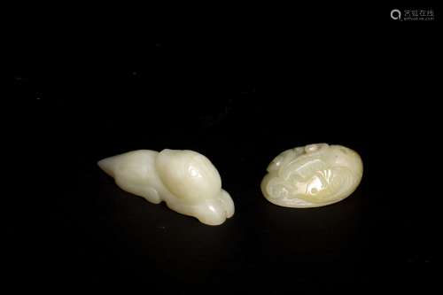 A GROUP OF TWO WHITE JADE TOGGLES