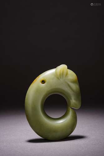 AN ARCHAIC CHINESE CELADON JADE CARVED 'PIG DRAGON'