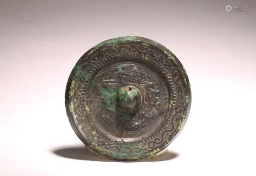 AN ARCHAIC CHINESE BRONZE MIRROR