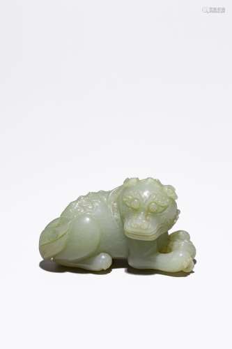 A SMALL CHINESE CELADON JADE CARVING OF LION