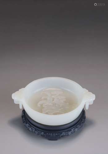 A CHINESE WHITE JADE 'ORCHID AND LINGZHI' WASHER