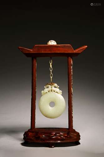 A CHINESE WHITE RUSSET JADE DISC BI ON WOODEN FRAME