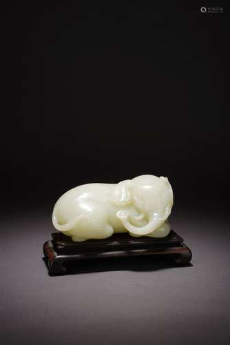 A CHINESE WHITE JADE CARVED RECUMBENT ELEPHANT