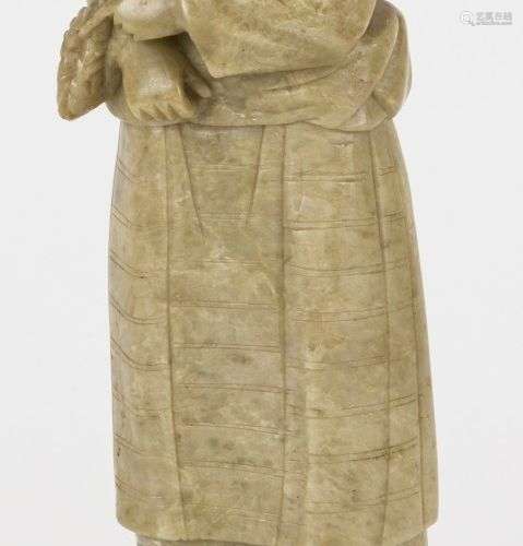 A soapstone sculpture of a farmer's wife with wheat in her h...