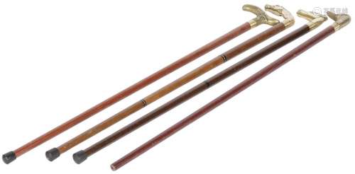 A lot comprised of (4) walking sticks, 20th century.