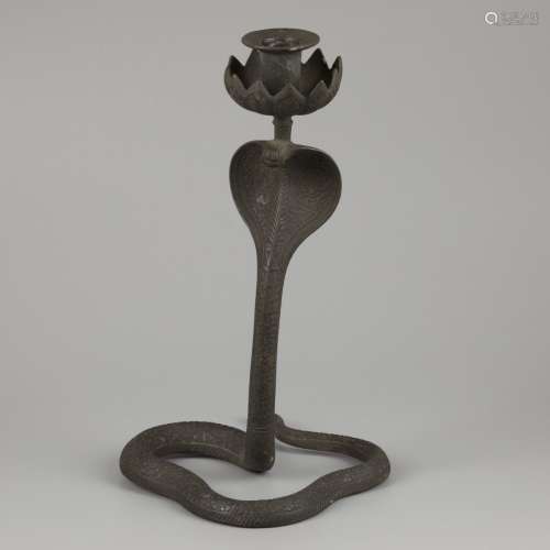 A bronze candle stick holder in Egyptian style, in the shape...
