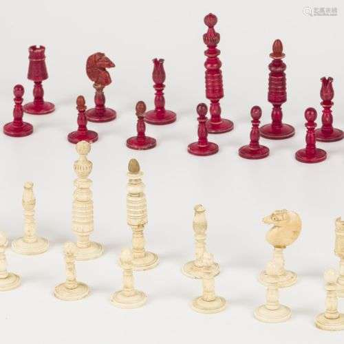 A bone partially coloured chess set.