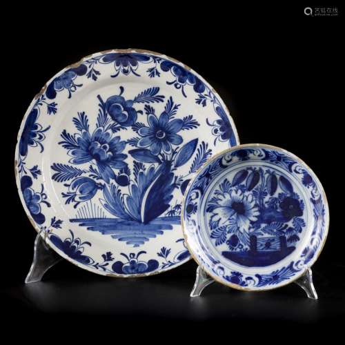 A lot comprising (2) earthenware chargers with floral decora...