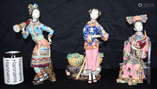 A set of three Chinese glazed pottery figures of females. 30...