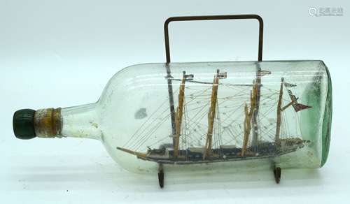 An antique ship in a bottle 30cm .