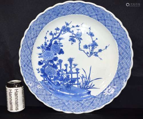 A large Japanese porcelain platter decorated with foliage an...