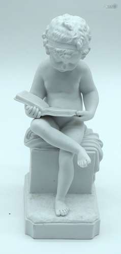 A small Parian ware figure of a child reading a book 20 cm.