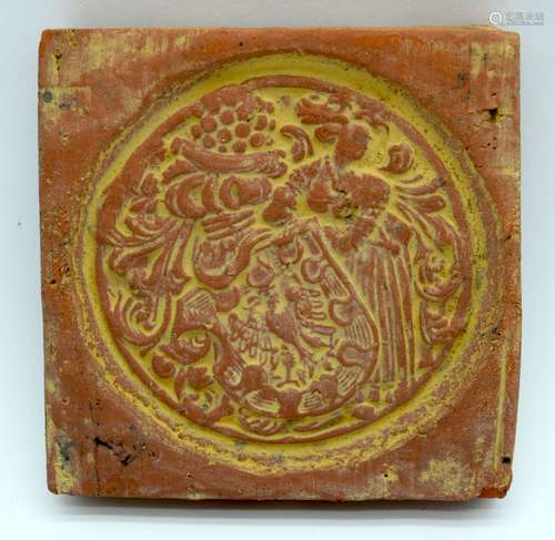 An early terracotta tile decorated with a soldier carrying a...