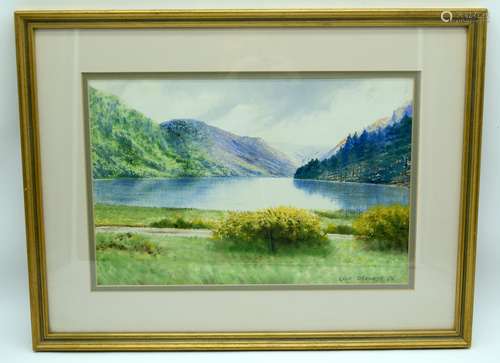 A framed watercolour by Liam O'Kennedy of a lake 24 x 38cm.