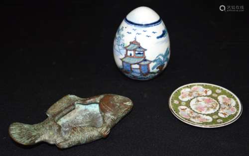 A Chinese bronze brush pot in the shape of a fish, together ...