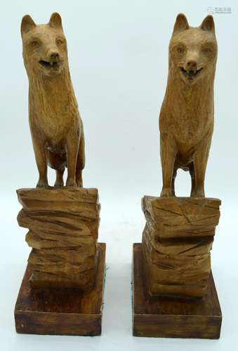 A pair of carved wooden sculptures of Wolves 45cm (2).