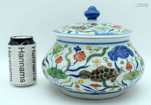 A Chinese porcelain Wucai jar and cover decorated with fish ...