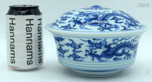 A Chinese blue and white lidded bowl decorated with dragons....