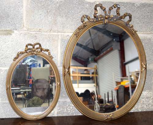 A large antique gilded plaster mirror together with a smalle...