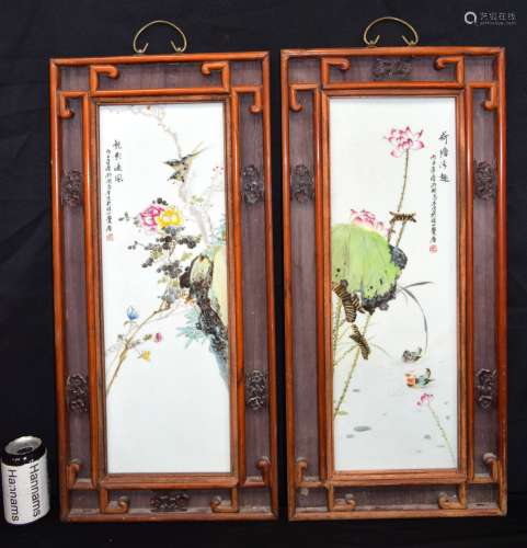 A pair of Chinese hardwood framed porcelain panels decorated...