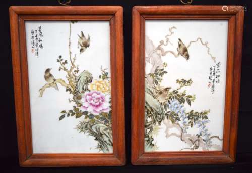 A pair of Chinese wooden framed porcelain panels decorated w...