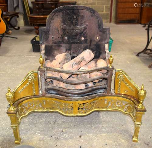 A gas fire with an ornate brass surround 77 x 77 x 37cm.