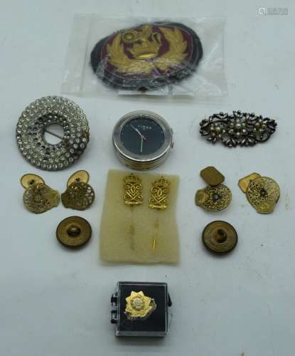 A collection of Military items pins, badge, buttons and cuff...