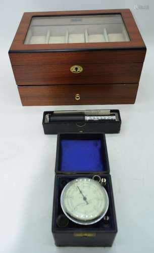 An Axis lockable watch case together with an Otis Kings calc...