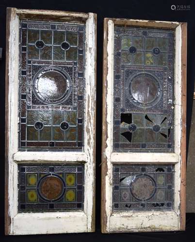 Two antique wooden framed leaded stain glass windows with a ...