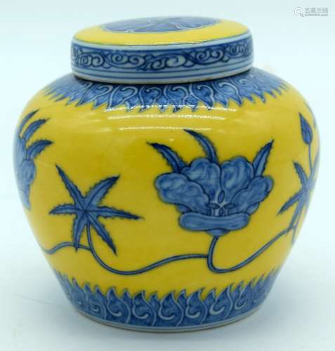 A small yellow ground ginger jar decorated with blue lotus f...